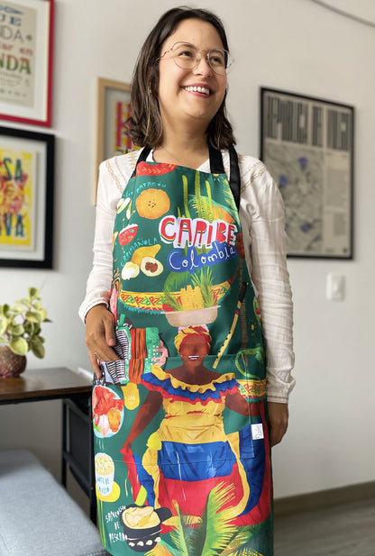 Delantal ilustrado "Caribe Colombia" con palenquera, acordeonero y gastronomía costeña — regalo colombiano cocina, souvenir del Caribe colombiano, gastronomía costeña, regalo de Cartagena, regalo de Barranquilla, regalo de santa marta, recuerdo de viaje original, regalos de la costa. Ailé