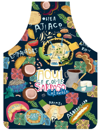 Delantal fondo azul oscuro navy con ilustración de gastronomía colombiana regional — platos nombrados: "Ajiaco", "Obleas", "Empanadas", "Aborrajado", "Arepita", "Roscón", "Pan de yuca", coco, chocolate. Texto central "Aquí se come sabroso Colombia" regalo sostenible, souvenir colombiano, recuerdo de viaje original, regalo para extranjeros, hecho en colombia. Ailé