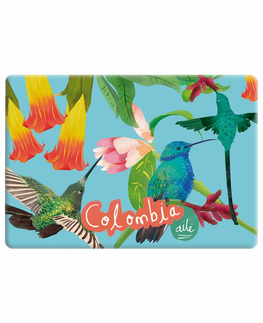 Imán souvenir Colombia ilustración "Colibrí Azul Colombia" — fondo celeste con colibríes en verde esmeralda, azul y amarillo, entre flores tropicales rojas y rosas. El colibrí es uno de los símbolos más icónicos de la biodiversidad colombiana imán biodiversidad colombiana, imán turístico Colombia, Colombian fauna magnet souvenir, imán regalo colombia, souvenir colombiano imán nevera, imán refrigerador colombiano, Colombian illustrated fridge magnet, recuerdo viaje Colombia imán, comprar imán souvenir. Ailé