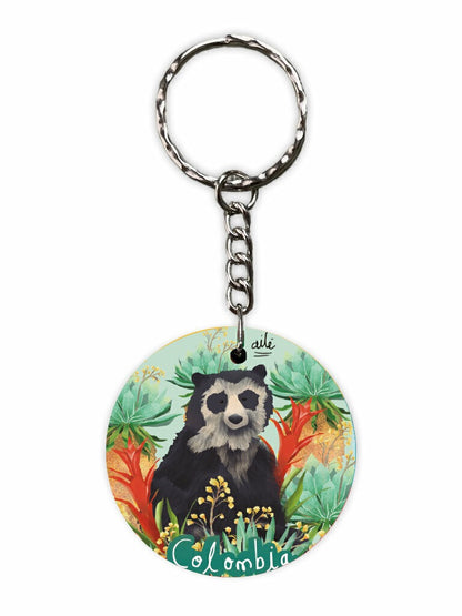 Llavero souvenir , lustrado con oso de anteojos y frailejones colombianos, flor del frailejón diseño original Ailé souvenir de fauna andina, oso de anteojos, especie endémica de los Andes de Colombia, oso de anteojos Colombia, oso andino colombiano, páramo colombiano ilustrado, frailejones Colombia, , llavero souvenir Colombia, regalo original llavero Colombia madera, llavero recuerdo Colombia, llavero artístico colombiano, llavero con diseño colombiano original. Ailé